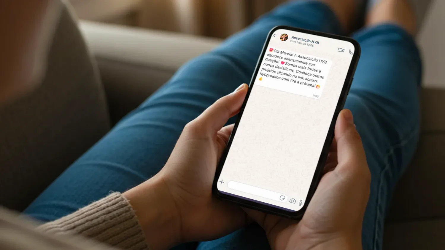 Doador segurando o celular e lendo a mensagem enviada pela organiza��o